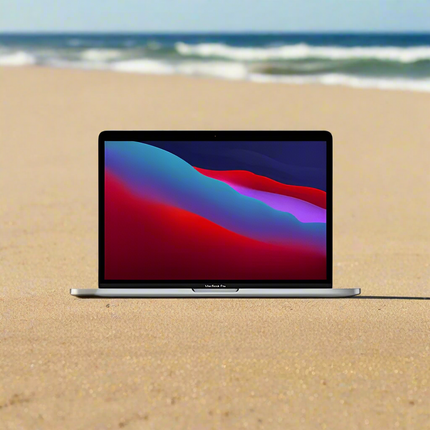 Laptop Apple MacBook Pro 13.3-Inch A2338 Laptop vtora upotreba  M1 - 8 cores on a sandy beach with ocean waves in the background