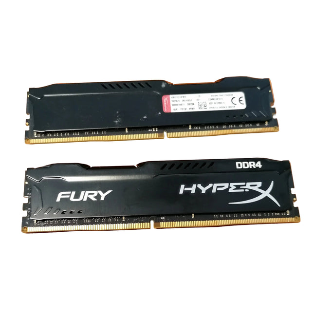 Two RAM sticks labeled 'FURY' and 'HYPERX' on a wooden surface.