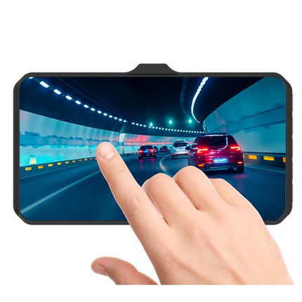 A smartphone with a black bezel and a curved top bar, shown on a white background with a human finger touching the screen. The screen displays a tunnel road scene with cars.
TRACER 4TS FHD CRUX Dash Cam FHD Videoregistrator 4.0D, Rezhim na parkirane, Detektor na dvizhenie