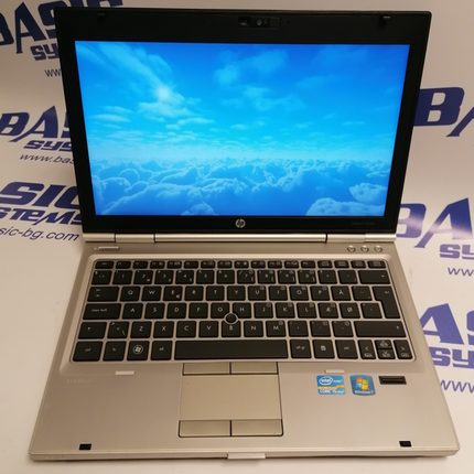 Поглед от горе на Лаптоп втора употреба HP EliteBook 2560p - CPU i5-2540М, 4GB RAM, 320GB HDD, в отворено  положение на дисплея. На бял фон с лого basic systems и www.basic-bg.com. Виждат се 12.5 инчов дисплей, камера, клавиатура втора ръка и тъчпад.