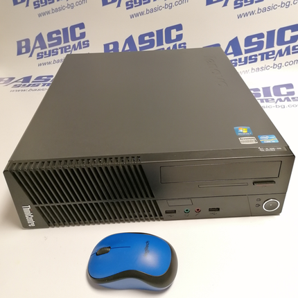 Десктоп кутия на компютър втора употреба ThinkCentre M72e и синя мишка заснети на фона на рекламни надписи Basic Systems