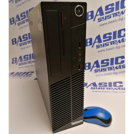 Десктоп кутия във вертикално положение на компютър втора ръка ThinkCentre M72e и синя мишка заснети на фона на рекламни надписи Basic Systems