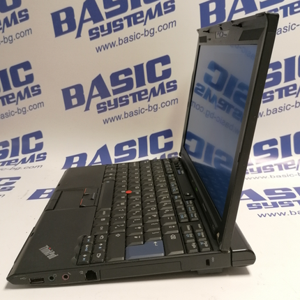 Поглед от дясно на Лаптоп втора употреба Lenovo ThinkPad X201 - CPU i5-580М, 4GB RAM, 128GB SSD. На бял фон с лого basic systems и www.basic-bg.com. Виждат се 12 инчов дисплей и клавиатура втора ръка, един USB порт, два аудио порта, лан порт RJ-45 и тъчпад.