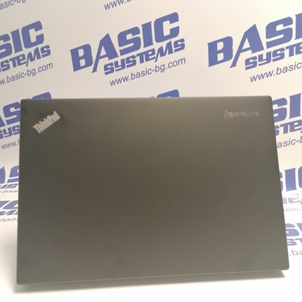 Поглед от задна страна на Лаптоп втора употреба Lenovo ThinkPad X240 - CPU i5-4300U, 8GB RAM, 128GB SSD. На бял фон с лого basic systems и www.basic-bg.com. Виждат логото Lenovo и ThinkPad на черен корпус на дисплея.
